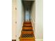Stairwell featuring wood stairs with decorative runners and neutral wall paint at 3210 Ebenezer Rd, Marietta, GA 30066