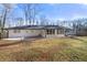 Exterior view of the home highlighting the backyard and a white painted brick home at 380 Atwood Nw Dr, Marietta, GA 30064