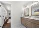 Well lit bathroom with double vanity, marble countertops, gold hardware and seating area with storage at 380 Atwood Nw Dr, Marietta, GA 30064