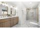 Bright bathroom featuring double vanity, marble countertops, and a sleek glass-enclosed shower with modern tile at 380 Atwood Nw Dr, Marietta, GA 30064