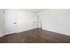 Bright bedroom with hardwood floors, white walls and trim, and multiple doors at 380 Atwood Nw Dr, Marietta, GA 30064