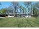 Charming single-story home featuring a manicured lawn, white painted brick, and a welcoming front porch at 380 Atwood Nw Dr, Marietta, GA 30064