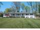 Charming single-story home featuring a manicured lawn, white painted brick, and a welcoming front porch at 380 Atwood Nw Dr, Marietta, GA 30064