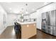 Bright kitchen with white cabinets, stainless steel appliances, and an island with bar seating at 380 Atwood Nw Dr, Marietta, GA 30064