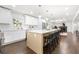 Open kitchen with an eat-in island, stainless appliances, and white cabinetry with a view of the living spaces at 380 Atwood Nw Dr, Marietta, GA 30064