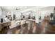 Bright, open-concept living room with hardwood floors seamlessly flows into the dining area and modern kitchen at 380 Atwood Nw Dr, Marietta, GA 30064
