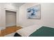 Bedroom featuring a closet and modern artwork, enhanced by warm hardwood floors at 242 12Th Ne St # 14, Atlanta, GA 30309