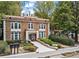 Beautiful exterior view of a brick apartment building surrounded by lush greenery at 242 12Th Ne St # 14, Atlanta, GA 30309