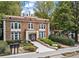 Brick building featuring a beautifully landscaped entrance walkway and mature trees at 242 12Th Ne St # 14, Atlanta, GA 30309