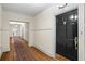 Hallway with hardwood floors leads to a front door and a glimpse of a bright living space at 242 12Th Ne St # 14, Atlanta, GA 30309