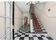 Inviting hallway features a striking black-and-white checkered floor and carpeted stairs at 242 12Th Ne St # 14, Atlanta, GA 30309