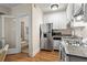 Efficient kitchen with stainless steel appliances, granite countertops, and an adjacent bathroom at 242 12Th Ne St # 14, Atlanta, GA 30309