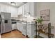 Well-equipped kitchen with stainless steel appliances, white cabinets, and stylish granite countertops at 242 12Th Ne St # 14, Atlanta, GA 30309