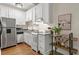 Efficient kitchen features white cabinets, granite countertops, and stainless steel appliances at 242 12Th Ne St # 14, Atlanta, GA 30309