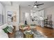 Cozy living room with hardwood floors flowing into a kitchen with white cabinetry and stainless steel appliances at 242 12Th Ne St # 14, Atlanta, GA 30309