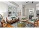 Living room with hardwood floors, accent chairs, sofa, modern art and a view into the bathroom at 242 12Th Ne St # 14, Atlanta, GA 30309