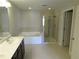 Bright bathroom featuring double vanity, soaking tub, and separate shower at 8265 Village Pl, Suwanee, GA 30024