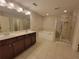 Bathroom showcasing double vanity, soaking tub, and glass enclosed shower at 8265 Village Pl, Suwanee, GA 30024