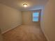 Neutral bedroom with carpet and one window for natural light at 8265 Village Pl, Suwanee, GA 30024