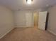 Bedroom with a closet, carpet, and multiple entry doors at 8265 Village Pl, Suwanee, GA 30024