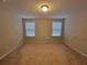 Bedroom with two windows and neutral carpeting at 8265 Village Pl, Suwanee, GA 30024