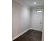 Bright entryway with hardwood floors, white door, and ample lighting at 8265 Village Pl, Suwanee, GA 30024