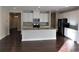 Open kitchen with white cabinets and stainless steel appliances at 8265 Village Pl, Suwanee, GA 30024