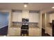 Modern kitchen featuring stainless steel appliances, granite countertops and sleek white cabinets at 8265 Village Pl, Suwanee, GA 30024