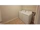Functional laundry room featuring a washing machine and dryer at 8265 Village Pl, Suwanee, GA 30024