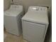 Bright laundry room featuring a white washing machine and dryer set for convenient chores at 8265 Village Pl, Suwanee, GA 30024