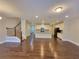 Open-concept living area with hardwood floors, modern lighting, and staircase access at 8265 Village Pl, Suwanee, GA 30024