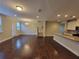Spacious living area with hardwood floors, staircase, and an open concept to the kitchen at 8265 Village Pl, Suwanee, GA 30024