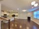 Bright living area featuring hardwood floors, fireplace, and kitchen with granite countertops at 8265 Village Pl, Suwanee, GA 30024