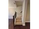Carpeted staircase with wooden railing and dark wood floors at 8265 Village Pl, Suwanee, GA 30024