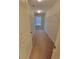 Neutral walk-in closet has shelving along the walls, carpet flooring, and a window for natural light at 8265 Village Pl, Suwanee, GA 30024