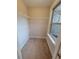 Small walk-in closet with a window, carpet, and shelving at 8265 Village Pl, Suwanee, GA 30024