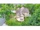 An aerial view showcasing the home's backyard with deck, patio, lush landscaping, and mature trees at 915 Chipley Ct, Marietta, GA 30062