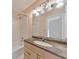 Bright bathroom featuring a tub-shower combo and a vanity with a stone countertop at 915 Chipley Ct, Marietta, GA 30062