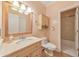Neutral bathroom featuring a wood-trimmed mirror, marble sink, and toilet at 915 Chipley Ct, Marietta, GA 30062