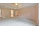 Spacious bedroom with a tray ceiling, plush carpeting, and ensuite bathroom at 915 Chipley Ct, Marietta, GA 30062