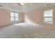 Spacious bedroom with a ceiling fan, neutral carpet, and natural light from two windows at 915 Chipley Ct, Marietta, GA 30062