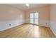 Light-filled bedroom with hardwood floors, neutral paint, and a large window at 915 Chipley Ct, Marietta, GA 30062
