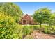 Beautiful red brick house with well maintained lawn, flowers, and mature trees at 915 Chipley Ct, Marietta, GA 30062