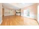 Spacious living room with gleaming hardwood floors, chandelier, built-in cabinets and view to the kitchen at 915 Chipley Ct, Marietta, GA 30062