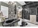 Unique bathroom featuring a black sink, toilet, tub and reflective tiles on the walls and ceiling at 145 15Th Ne St # 409, Atlanta, GA 30309