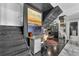 Hallway with desk nook, stairway, tiled flooring, and view into a kitchen with stainless steel appliances at 145 15Th Ne St # 409, Atlanta, GA 30309