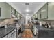 Modern kitchen featuring updated appliances, olive colored cabinets and stylish countertops at 145 15Th Ne St # 409, Atlanta, GA 30309