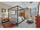 Well-lit bedroom with carpet, a four-poster bed, light-colored furnishings, and a window at 145 15Th Ne St # 409, Atlanta, GA 30309