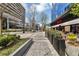 Commercial street with planters, businesses, and sidewalk seating at 145 15Th Ne St # 409, Atlanta, GA 30309