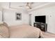 Bedroom boasts a tray ceiling, ceiling fan, and a modern entertainment setup at 1590 Ridgebrook Downs, Mableton, GA 30126